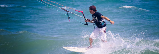 Kiteboarder wave riding